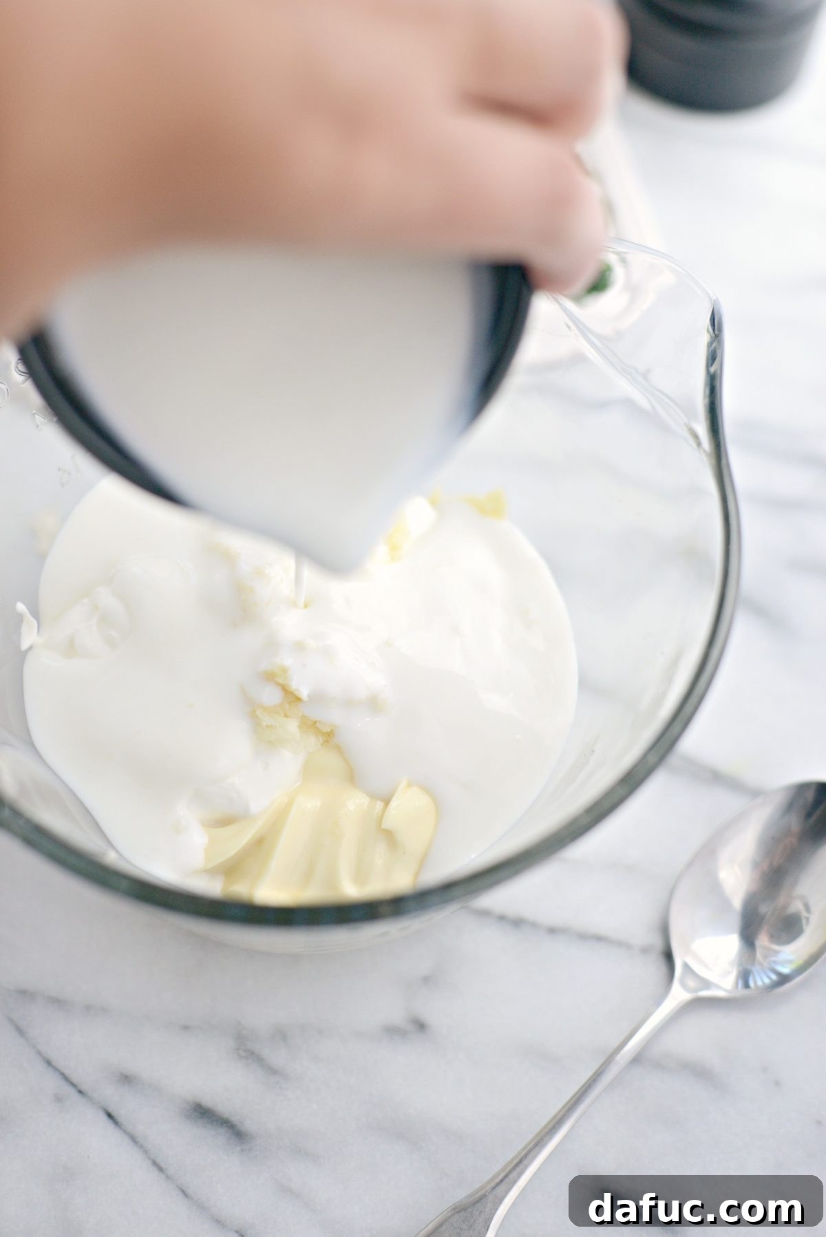 Farmhouse Ranch 5 Pouring buttermilk into the bowl with mayo, sour cream, and garlic