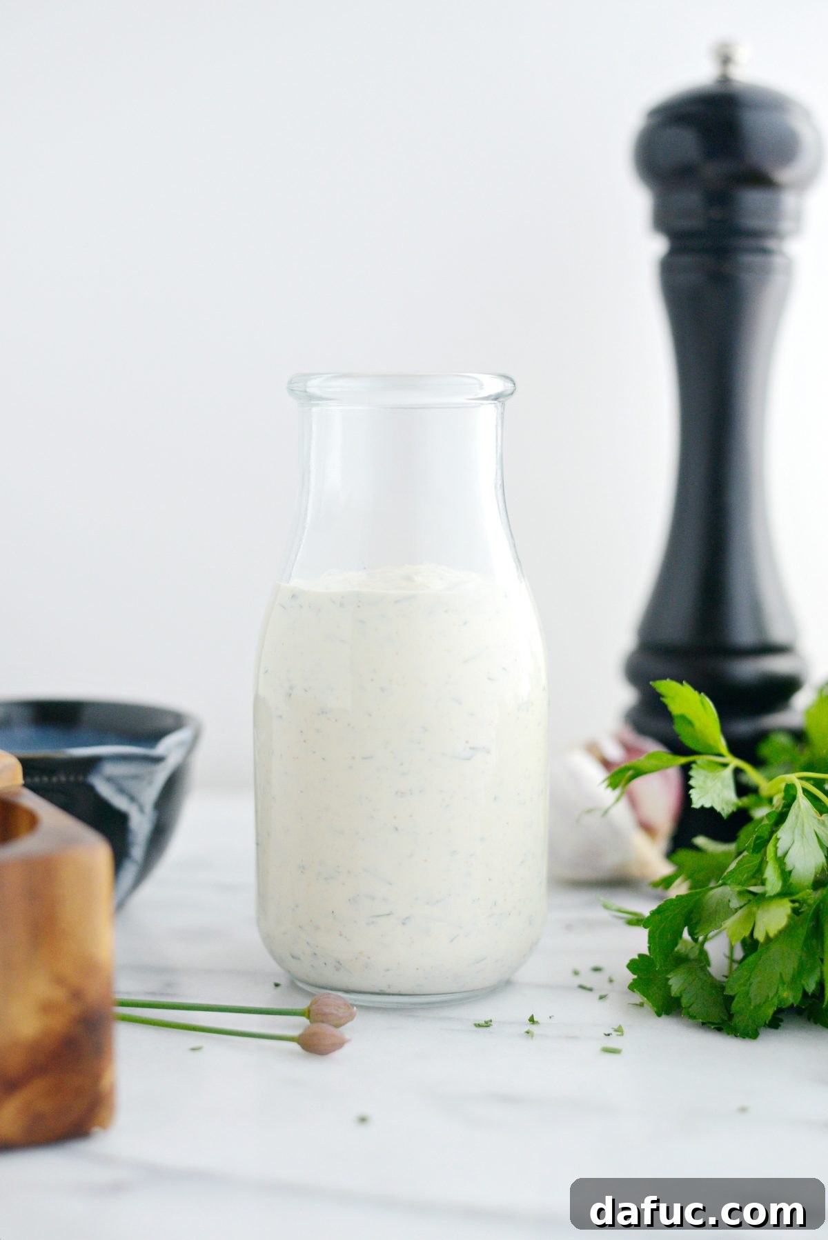 Farmhouse Ranch 10 Close-up of a glass bottle filled with creamy Buttermilk Ranch Dressing