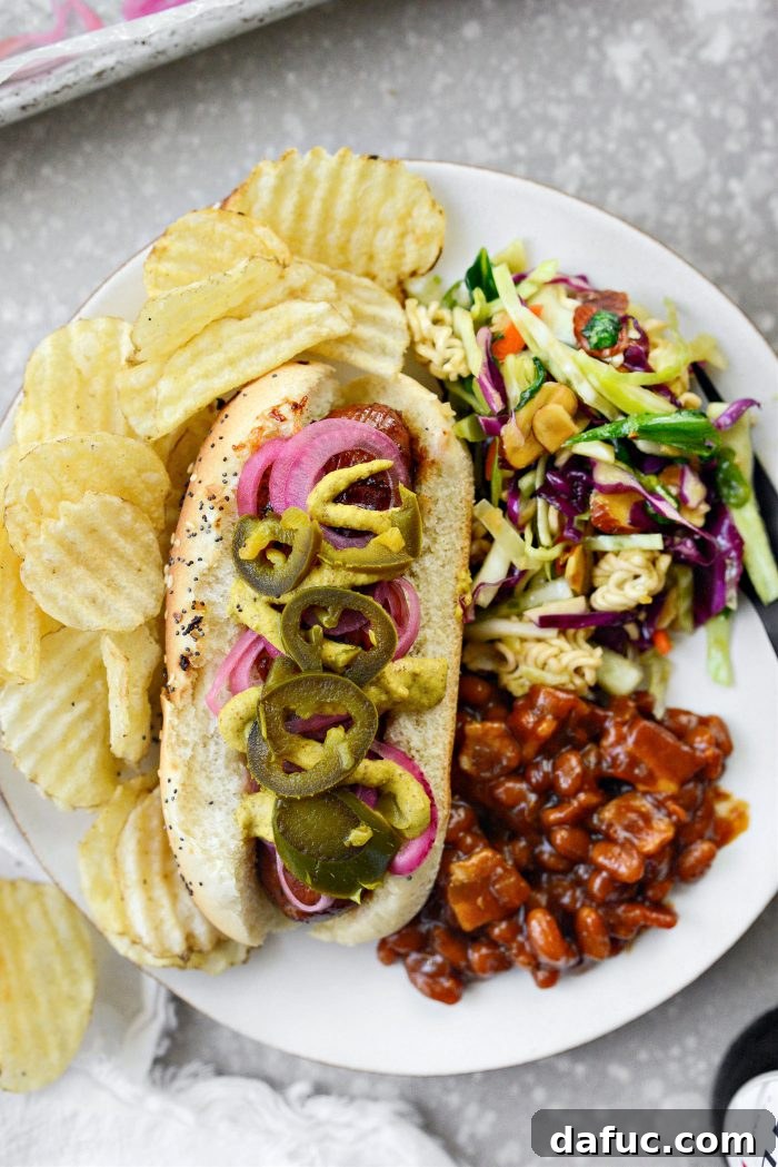 Smoky BBQ Glazed Chicken Brats 11 A complete meal setting with Grilled BBQ Sauce Chicken Brats and various side dishes.