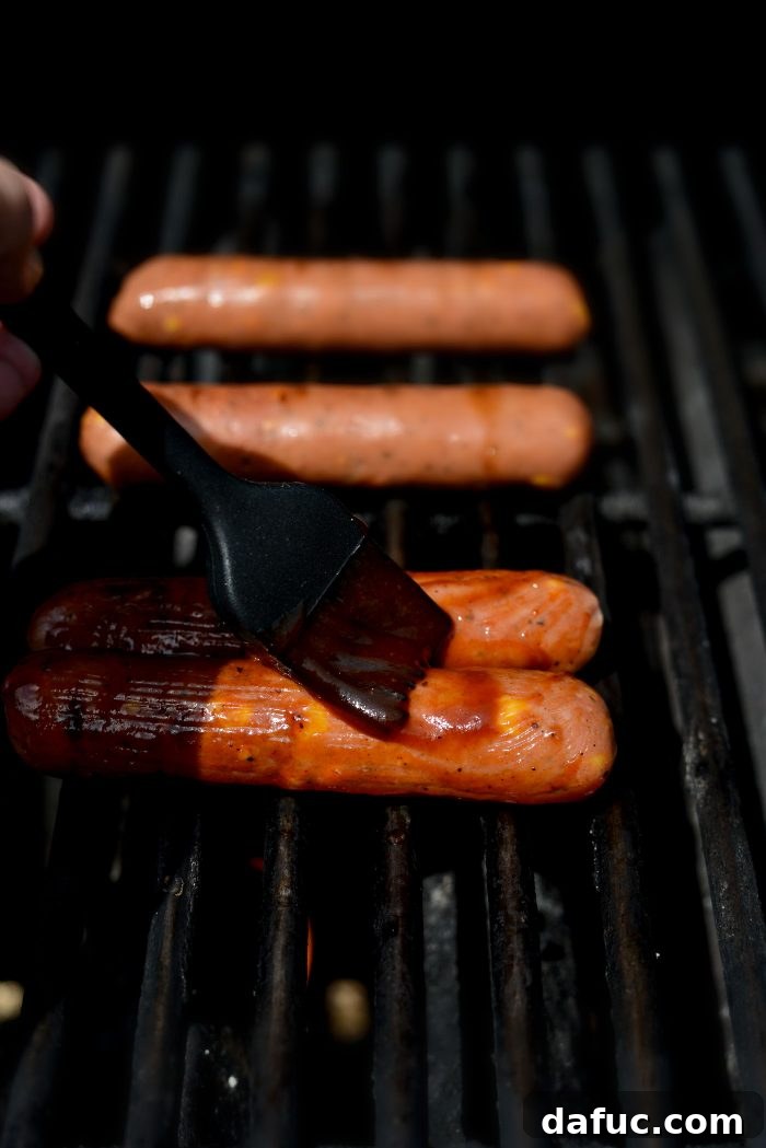 Smoky BBQ Glazed Chicken Brats 5 Grilling chicken brats and brushing them with BBQ sauce to create a sticky glaze.