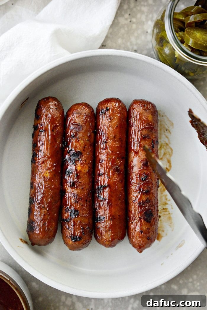 Smoky BBQ Glazed Chicken Brats 7 A platter of saucy grilled chicken brats ready for assembly.