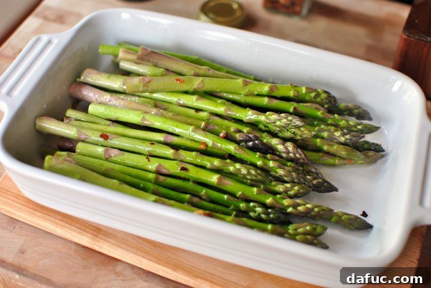 Tossing asparagus with olive oil and spices