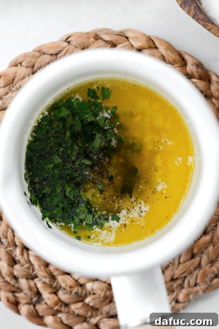 Combining melted butter, garlic, parsley, lemon juice, salt, and pepper in a small bowl