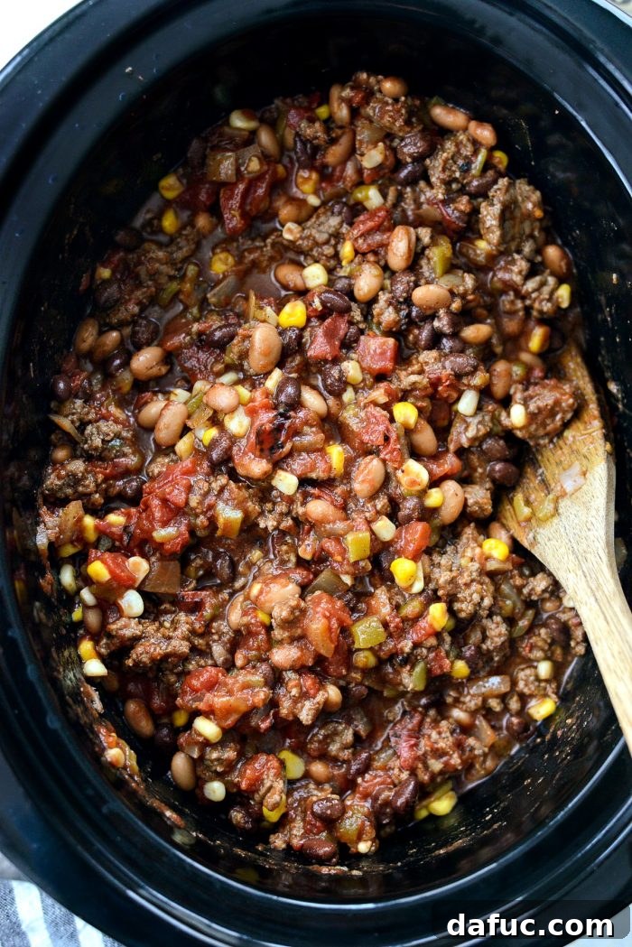 Fiesta Slow Cooker Taco Chili 9 All the main ingredients for Slow Cooker Taco Chili — drained pinto and black beans, diced green chiles, sweet corn, and crushed fire-roasted tomatoes — added to the slow cooker.