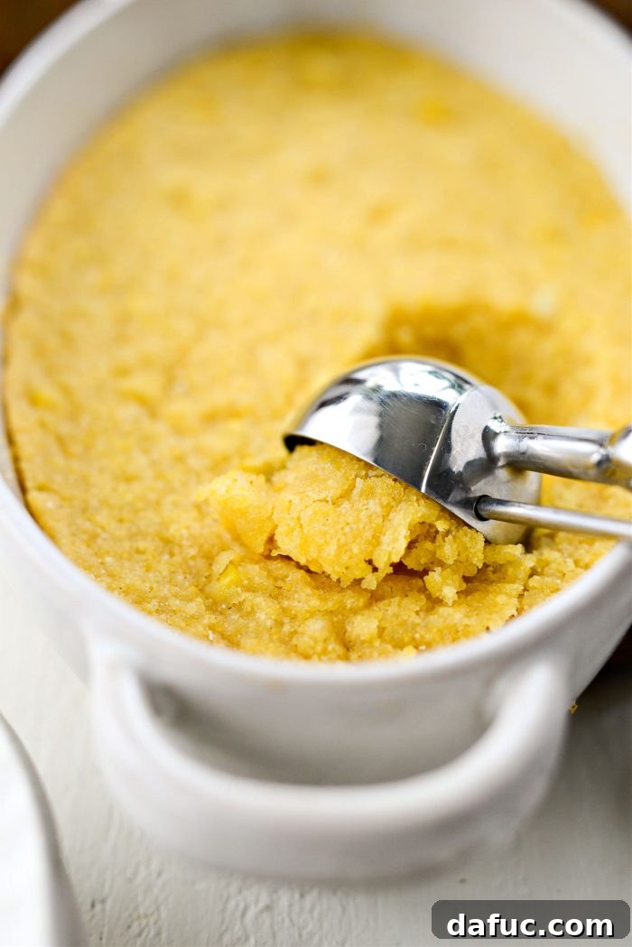 Sweet Mexican Cornbread 13 A scoop of Mexican Sweet Corn Cake being taken from the baking dish, revealing its soft interior