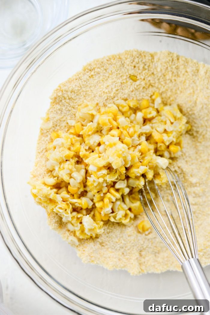 Sweet Mexican Cornbread 7 Roughly chopped sweet corn being added to the bowl of whisked dry ingredients