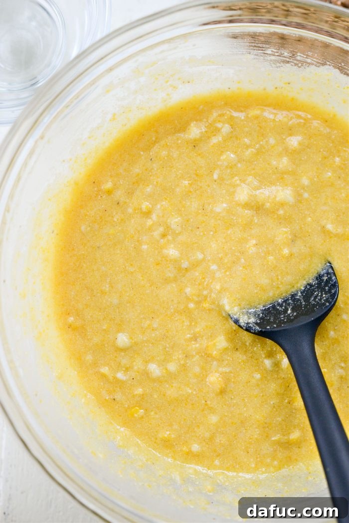 Sweet Mexican Cornbread 9 The wet and dry ingredients being stirred together to form a smooth batter