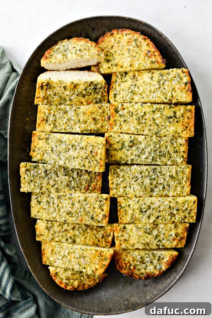 Aromatic Garlic Parmesan Bread 12 A large tray of sliced Parmesan Garlic Bread ready to be served
