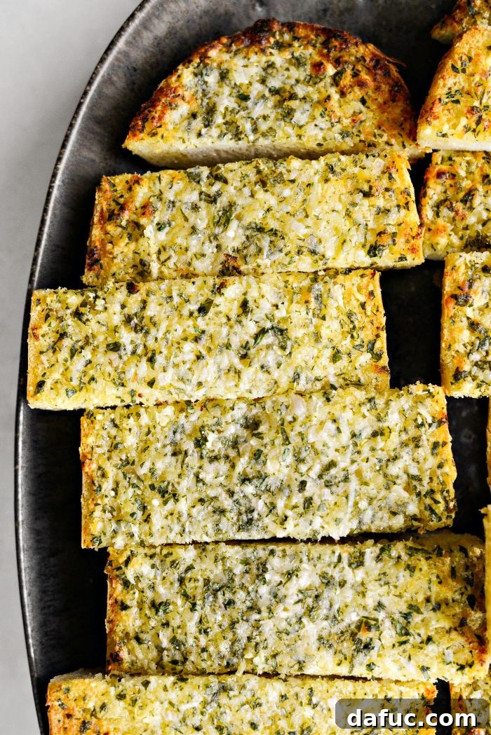 Aromatic Garlic Parmesan Bread 15 Parmesan Garlic Bread beautifully arranged on a serving board with a sprig of rosemary