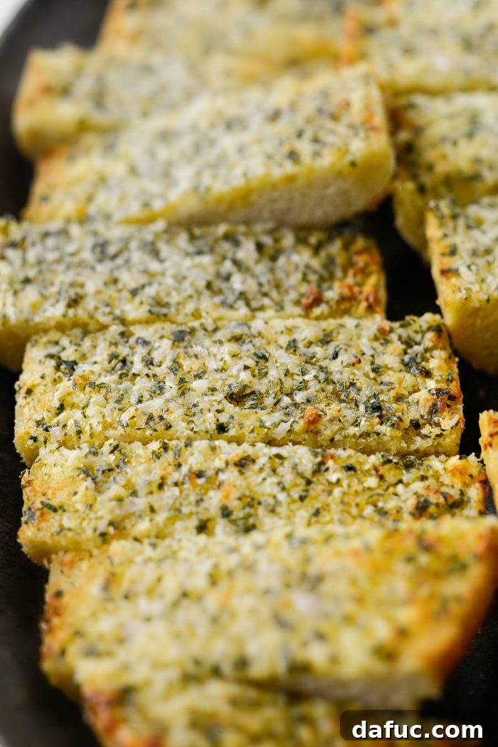Aromatic Garlic Parmesan Bread 3 Close-up of freshly baked Parmesan Garlic Bread showing melted cheese and herbs