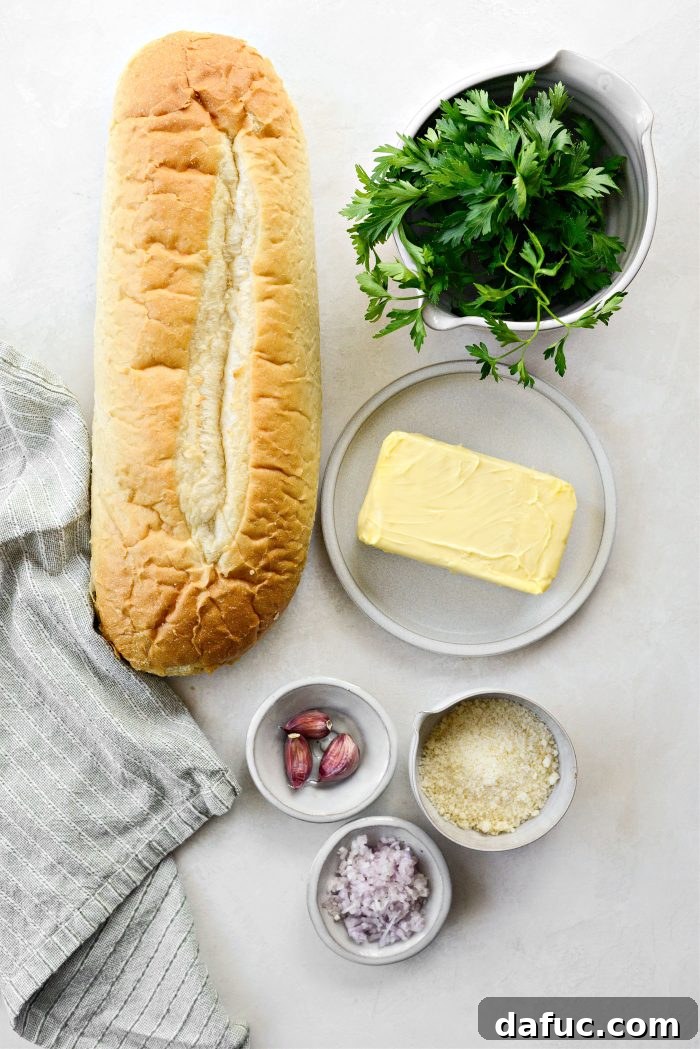 Aromatic Garlic Parmesan Bread 4 Ingredients for Parmesan Garlic Bread laid out on a wooden surface