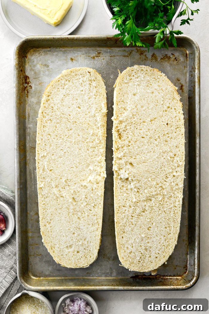 Aromatic Garlic Parmesan Bread 5 Italian bread sliced horizontally and placed on a large rimmed baking sheet