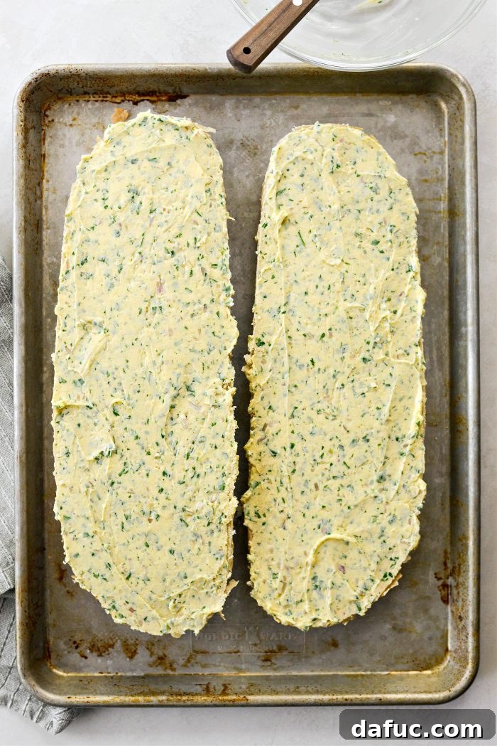 Aromatic Garlic Parmesan Bread 10 Dividing and spreading the butter mixture onto the halved Italian bread