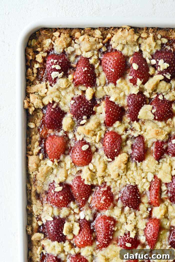 Freshly baked strawberry streusel bars cooling on a wire rack