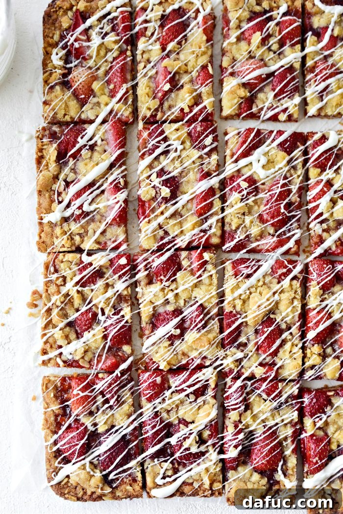 Close-up of baked Strawberry Streusel Bars showing the oatmeal crust, strawberry filling, and crumb topping