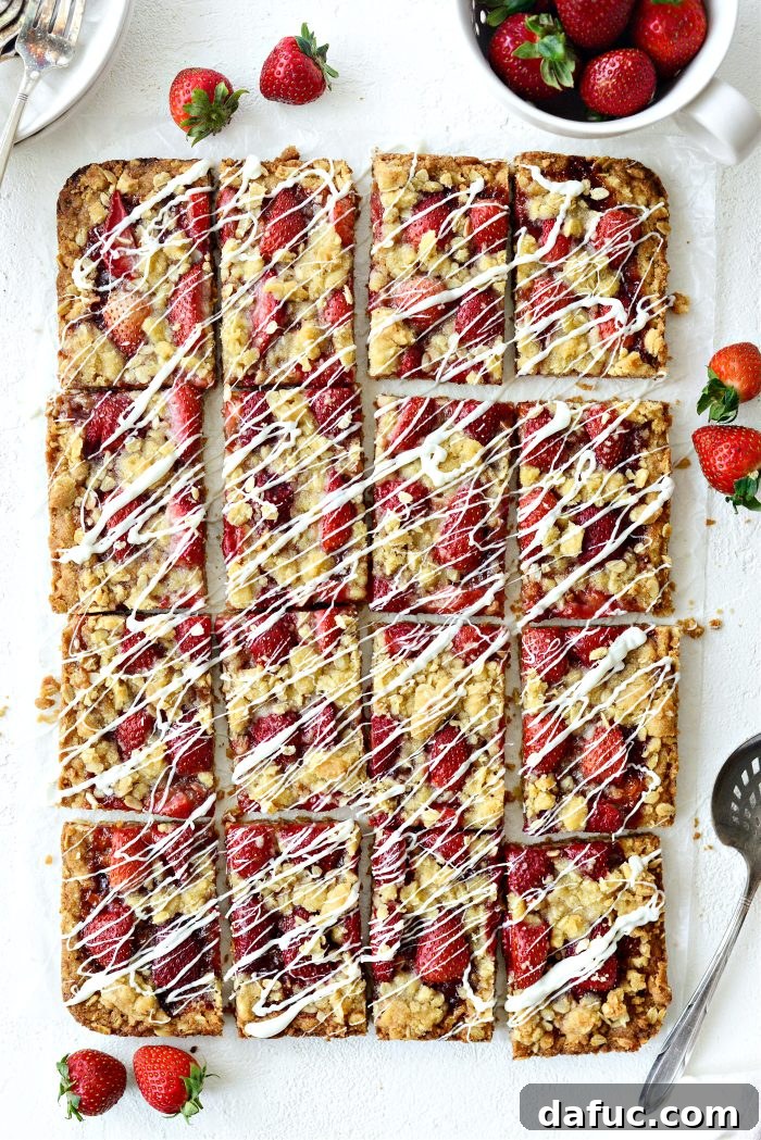 Closeup of a single Strawberry Streusel Bar showcasing its layers and white chocolate drizzle
