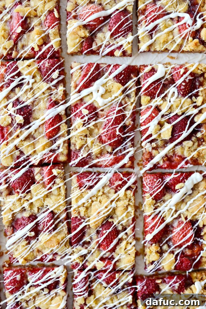 Stack of freshly baked Strawberry Streusel Bars on a white background