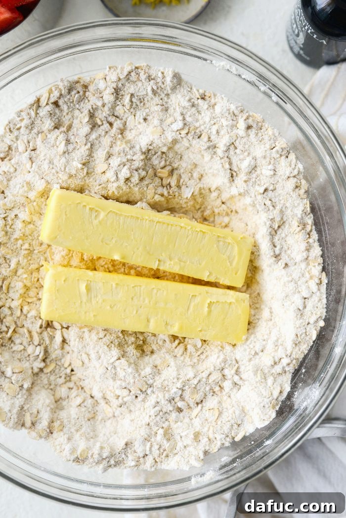 Adding cold unsalted butter cubes to the dry streusel mix