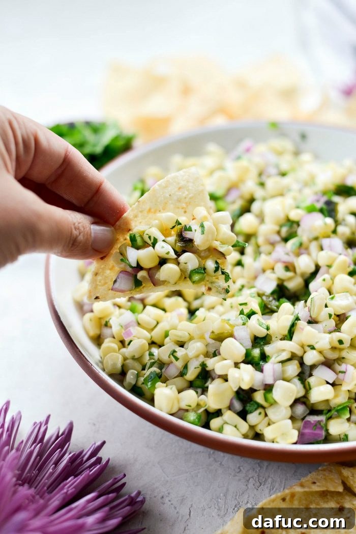 Chipotle's Signature Sweet Corn Salsa 13 A final close-up shot of the Chipotle Sweet Corn Salsa in a serving bowl, showcasing its appetizing texture and fresh ingredients, suggesting the delicious outcome of the recipe.