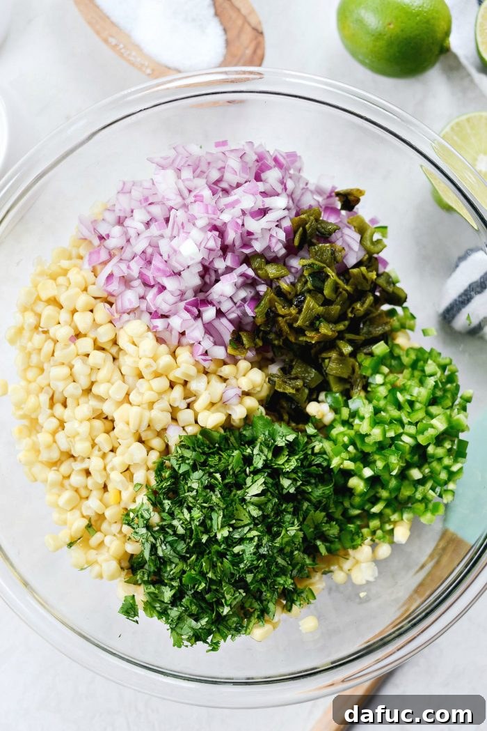 Chipotle's Signature Sweet Corn Salsa 7 Finely diced, deseeded, and peeled poblano peppers displayed on a wooden cutting board, ready to be incorporated into the sweet corn salsa. This image shows the perfectly prepared pepper pieces.
