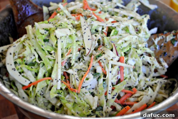 Fresh Apple Cabbage Slaw with Creamy Poppy Seed Dressing in a serving bowl