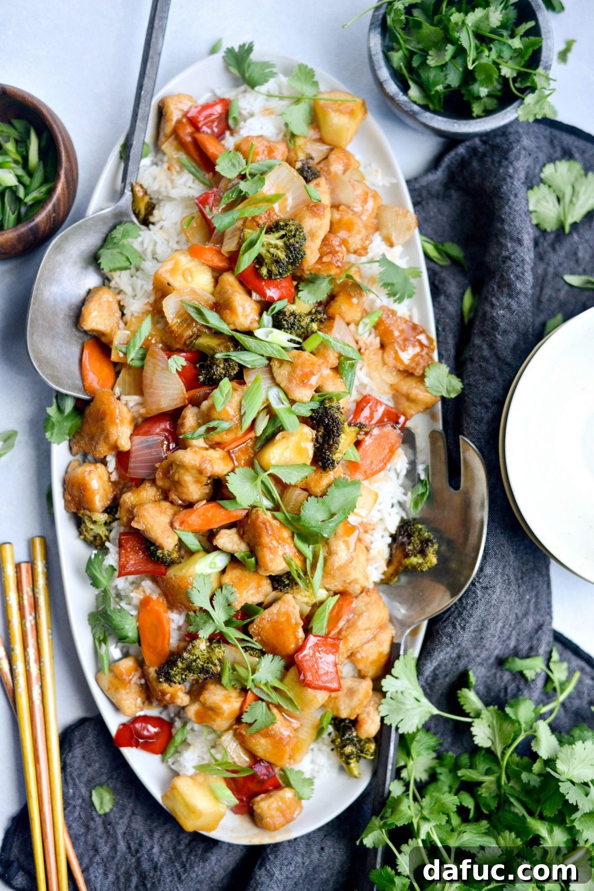 Homemade Sweet and Sour Chicken served on white platter with rice