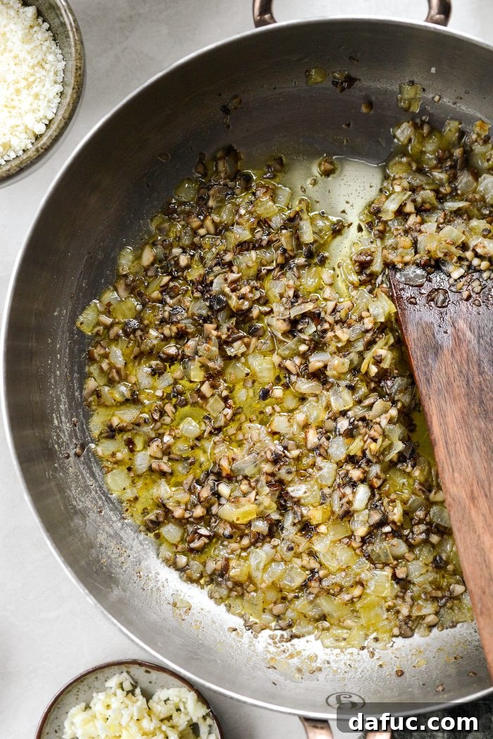 Crispy Shallot Green Bean Casserole 14 Onions and mushrooms sautéing together in a skillet, developing rich flavors.