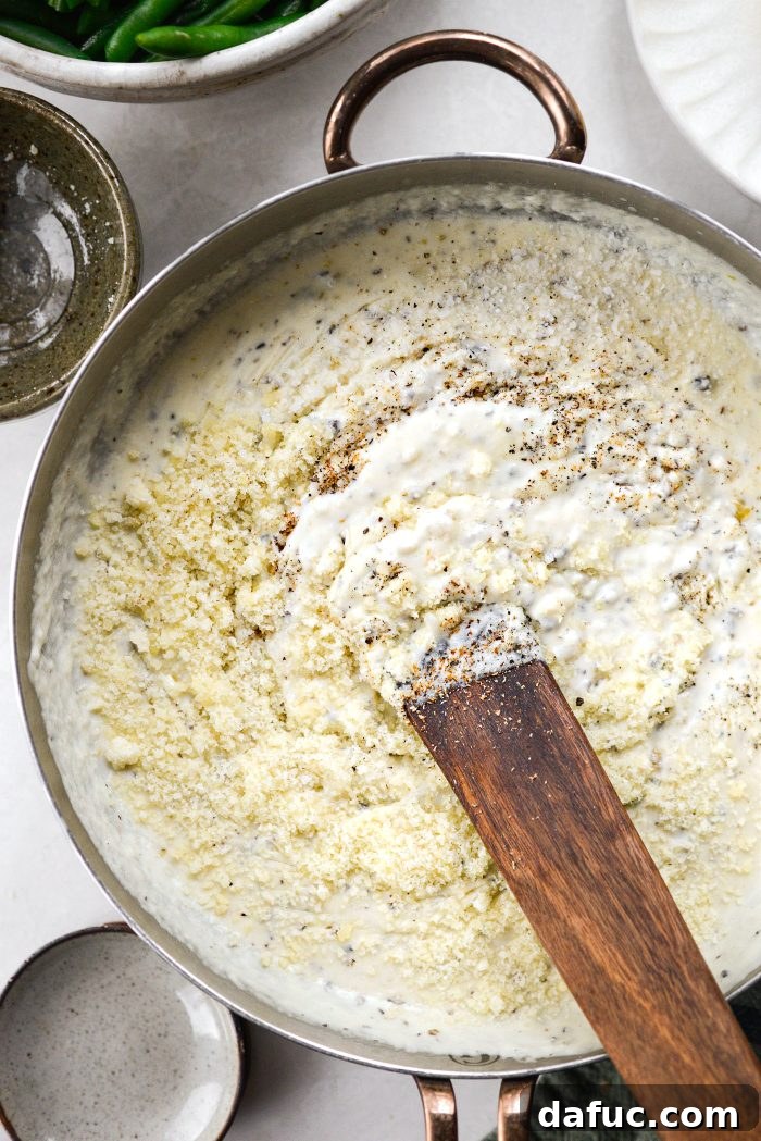 Crispy Shallot Green Bean Casserole 19 The creamy sauce being stirred to combine all the seasonings and cheese.