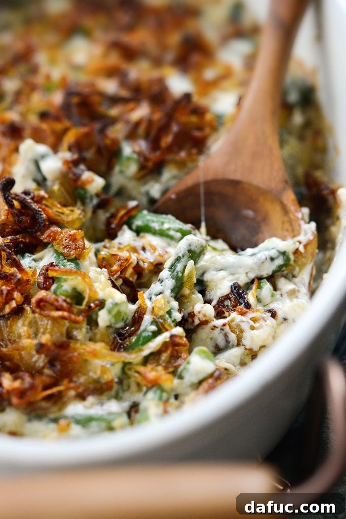 Crispy Shallot Green Bean Casserole 3 A close-up view of the Homemade Green Bean Casserole with Fried Shallots, highlighting the creamy texture and crispy topping.