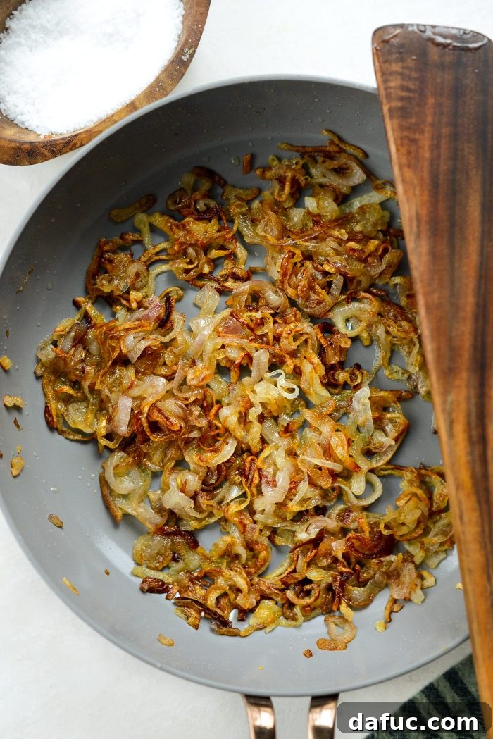 Crispy Shallot Green Bean Casserole 24 Fried shallots in a skillet, slightly crispy and golden brown.