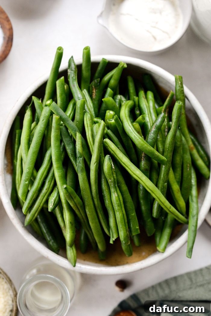Crispy Shallot Green Bean Casserole 6 A bowl filled with fresh, vibrant green beans, ready for preparation.