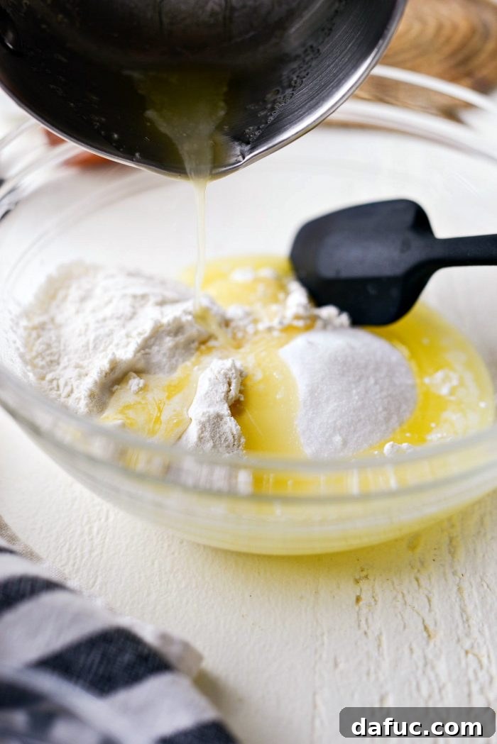 Martha Sweet Rhubarb Flip 5 Pouring melted butter into a bowl with flour and sugar for the crumble topping