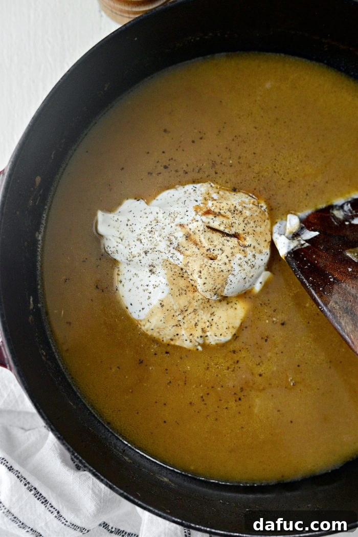 Hearty Homestyle Beef Stroganoff 22 Adding sour cream, Worcestershire sauce, and black pepper to the sauce