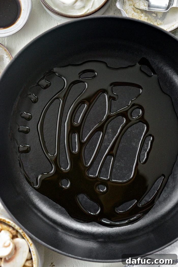 Hearty Homestyle Beef Stroganoff 8 Olive oil heating in a deep-sided skillet