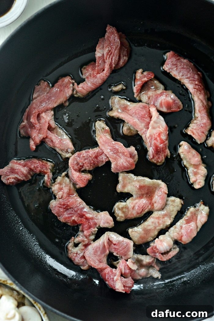 Hearty Homestyle Beef Stroganoff 9 Searing sliced steak in batches in a hot skillet