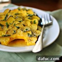A close-up image of roasted acorn squash with brown butter and crispy sage.