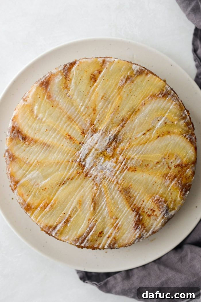 Caramelized Ginger Pear Invert 24 Inverting the Ginger Pear Upside Down Cake onto a platter