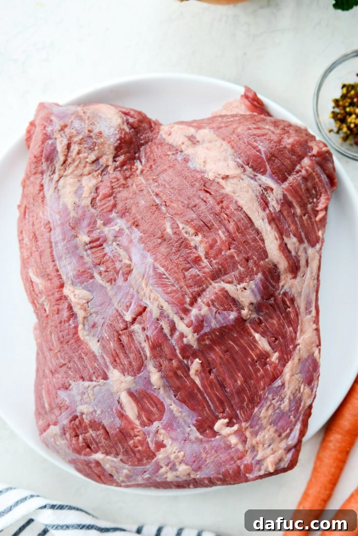 Succulent Corned Beef and Cabbage 6 Raw corned beef brisket, ready for rinsing and cooking, showcasing its distinctive color and texture
