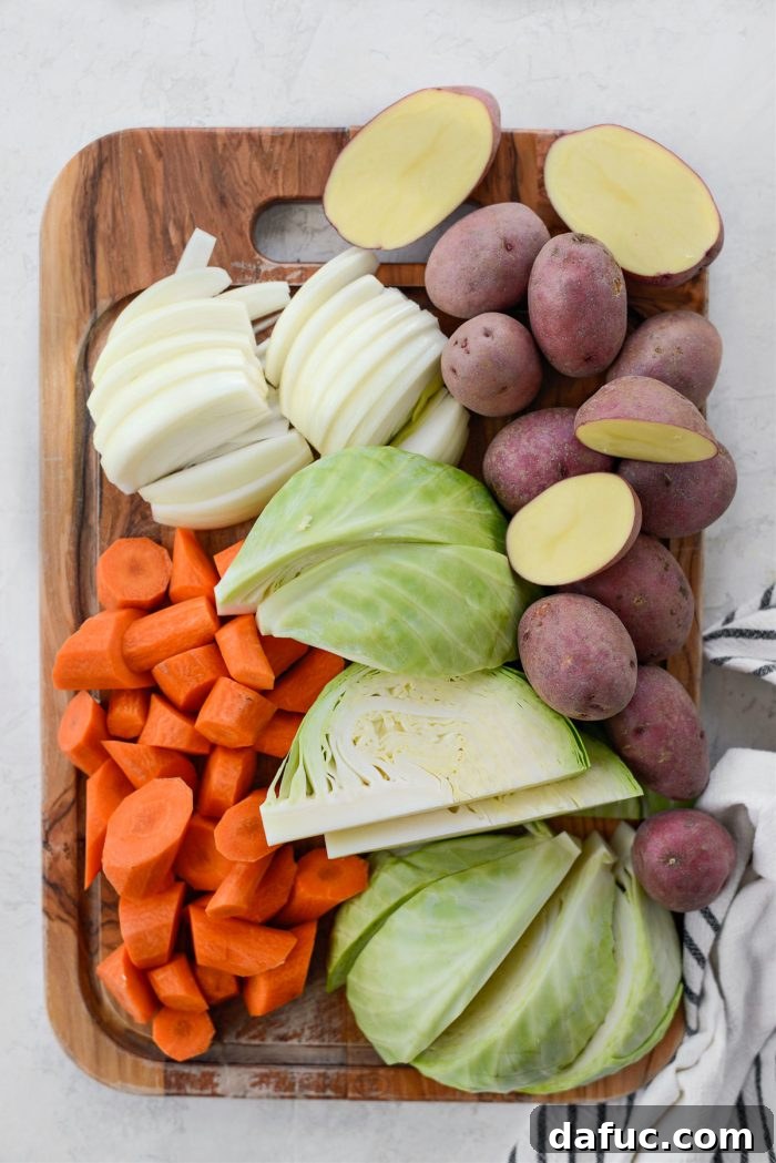 Succulent Corned Beef and Cabbage 9 Prepped carrots, onions, potatoes, and cabbage wedges neatly arranged, ready to be added to the pot
