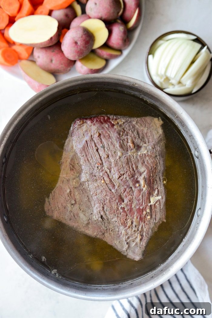 Succulent Corned Beef and Cabbage 10 The fully cooked and tender corned beef brisket, removed from the pot and resting on a carving board
