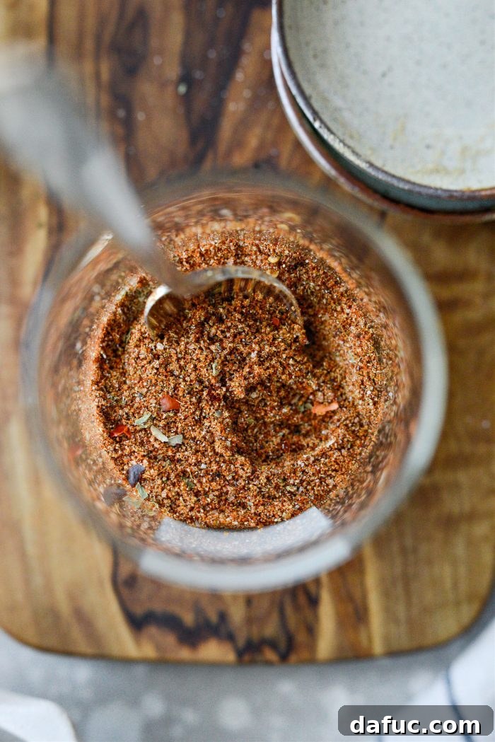 Stirring the combined taco seasoning mixture in a bowl
