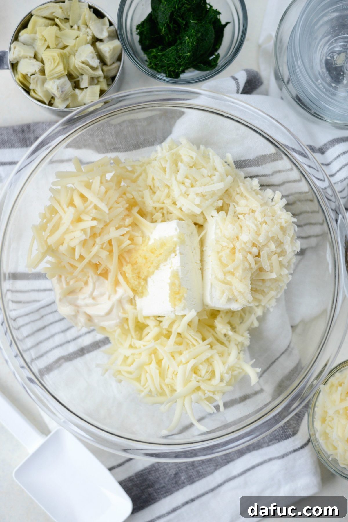 Add the different cheeses into the bowl.