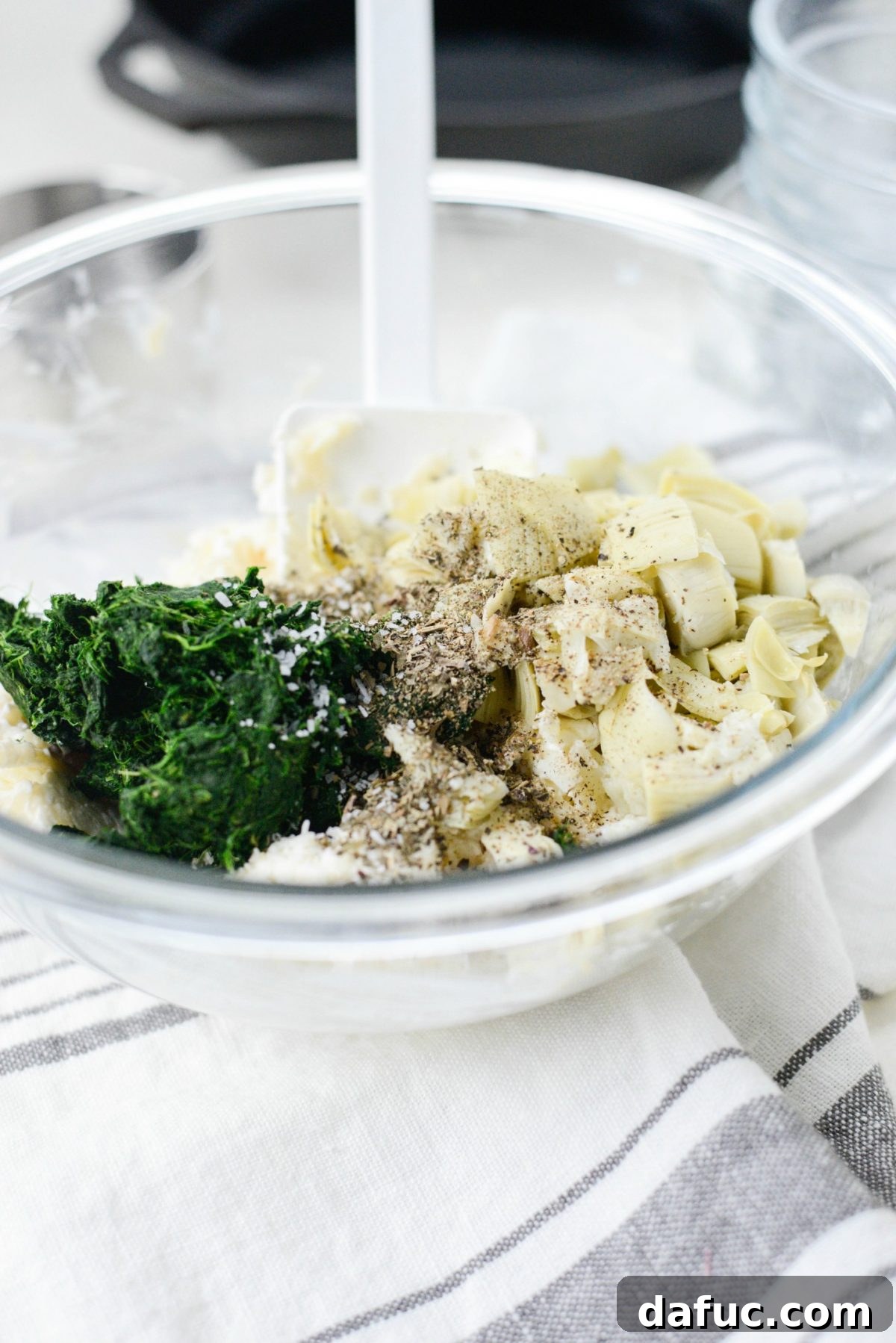 Add spinach, artichokes and dried herbs and spices.