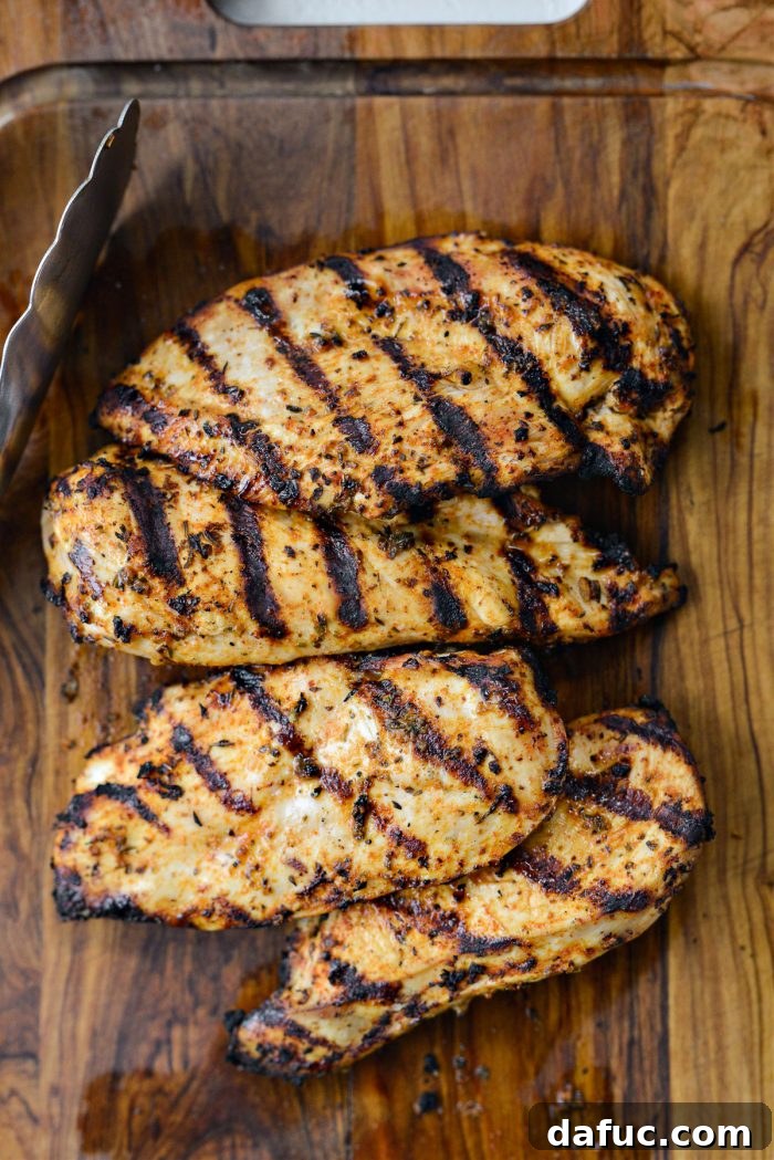 Vibrant Bruschetta Chicken Pizza 7 Grilled chicken breast cooking on a hot outdoor grill