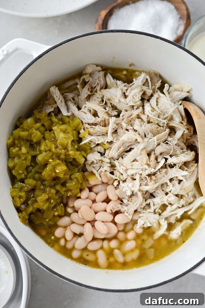 Velvety White Chicken Chili 13 add the chicken back to the pot with green chiles and beans