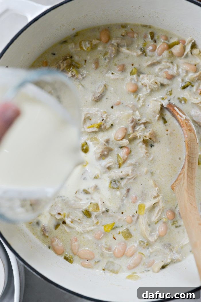 Velvety White Chicken Chili 16 Stir and pour in heavy cream