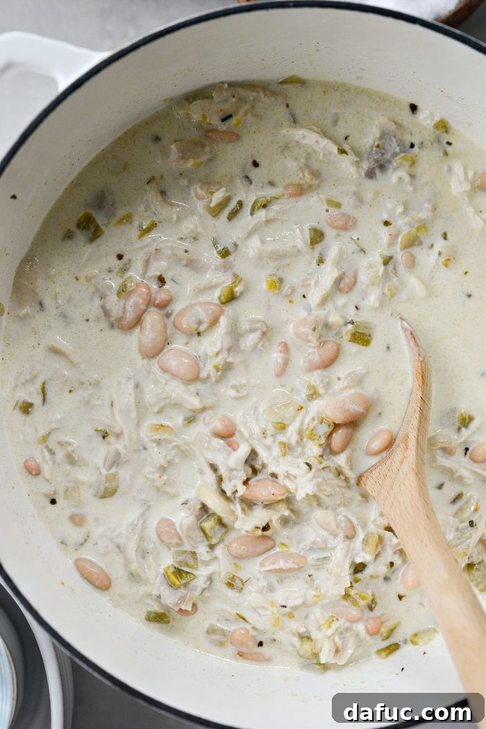 Velvety White Chicken Chili 17 Stir to combine and season with salt