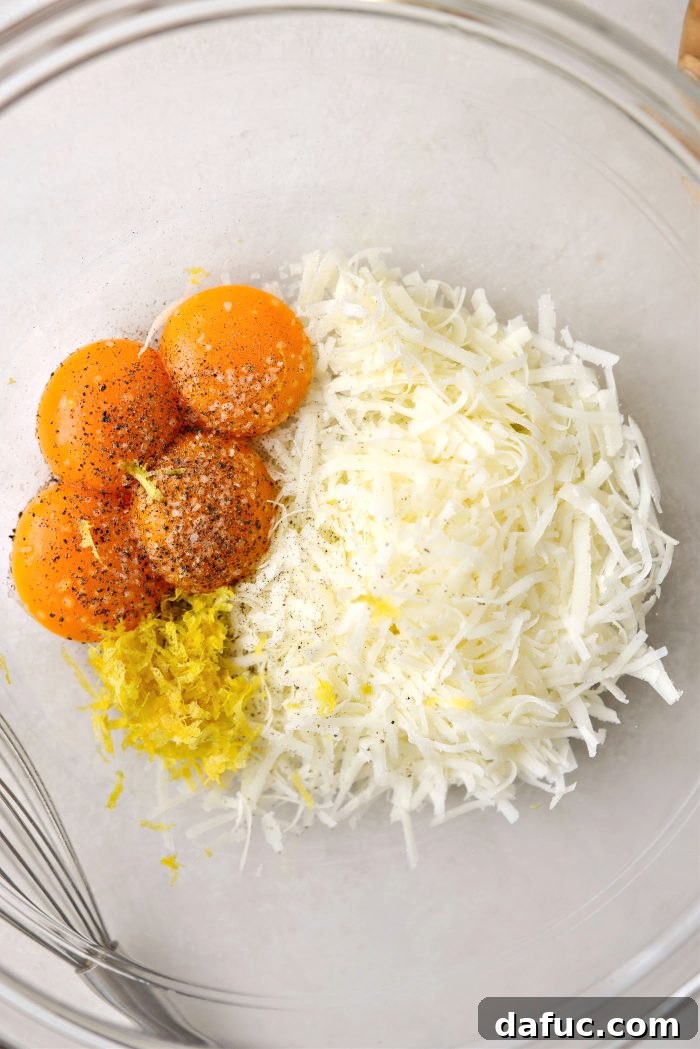 in a bowl add egg yolks, cheese, lemon zest, salt and pepper