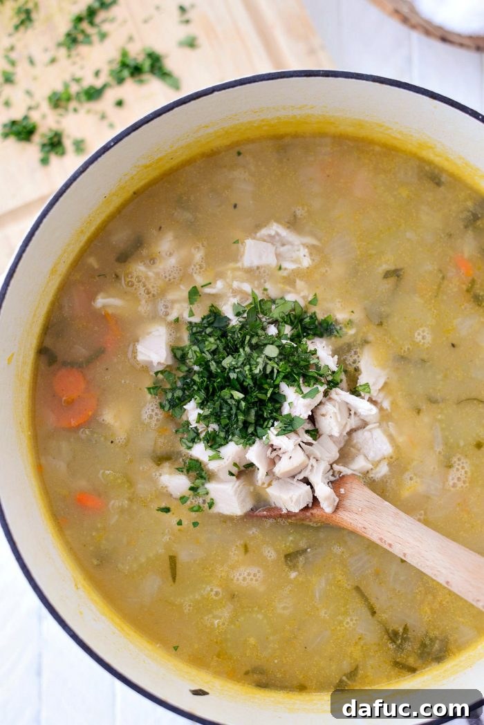 Adding shredded cooked turkey and fresh parsley to the thickened turkey pot pie soup. Keywords: homemade, turkey, potpie, soup, leftover, fromscratch, thanksgiving, leftovers