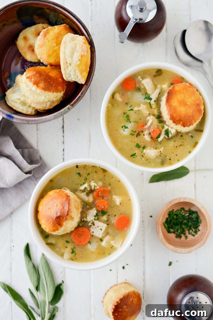 Served bowl of Homemade Turkey Pot Pie Soup with a golden puff pastry topping. Keywords: homemade, turkey, potpie, soup, leftover, fromscratch, thanksgiving, leftovers